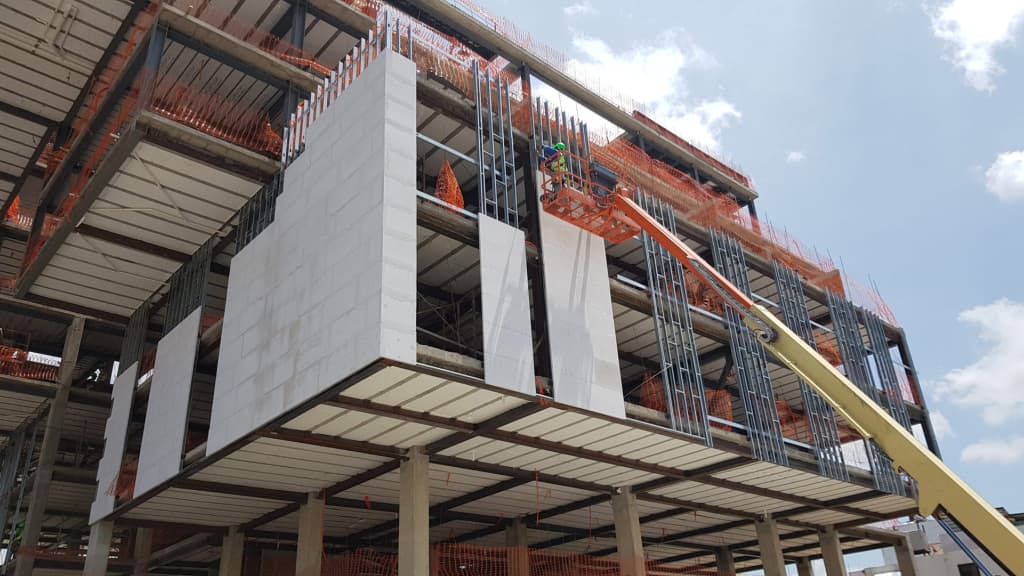 AAC panels being installed on a multi-storey commercial building frame